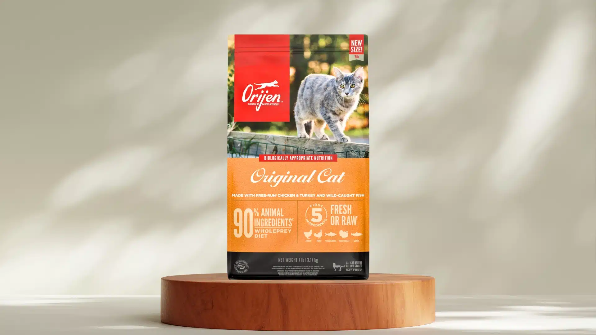 Orijen Original Cat dry food bag on wooden stand with gray cat image and orange label showing high protein diet
