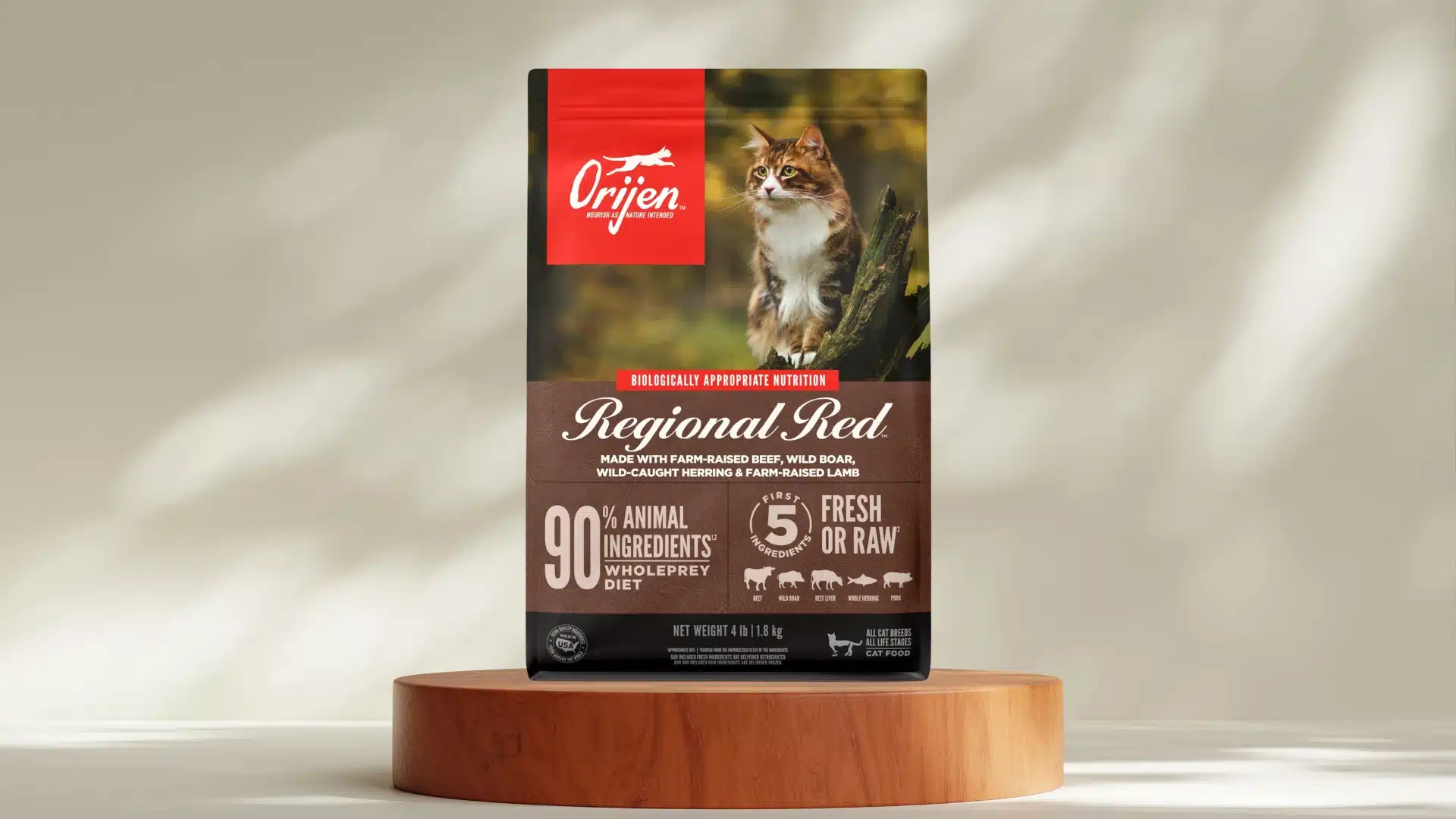 Orijen Regional Red cat food bag on wooden stand with long haired cat image and brown label high meat formula
