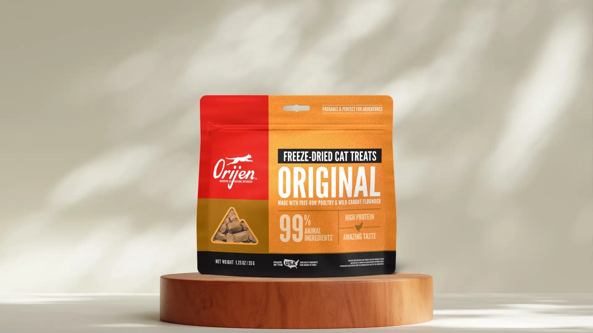 Orijen Original freeze dried cat treats pack on wooden stand with high protein label and poultry ingredients